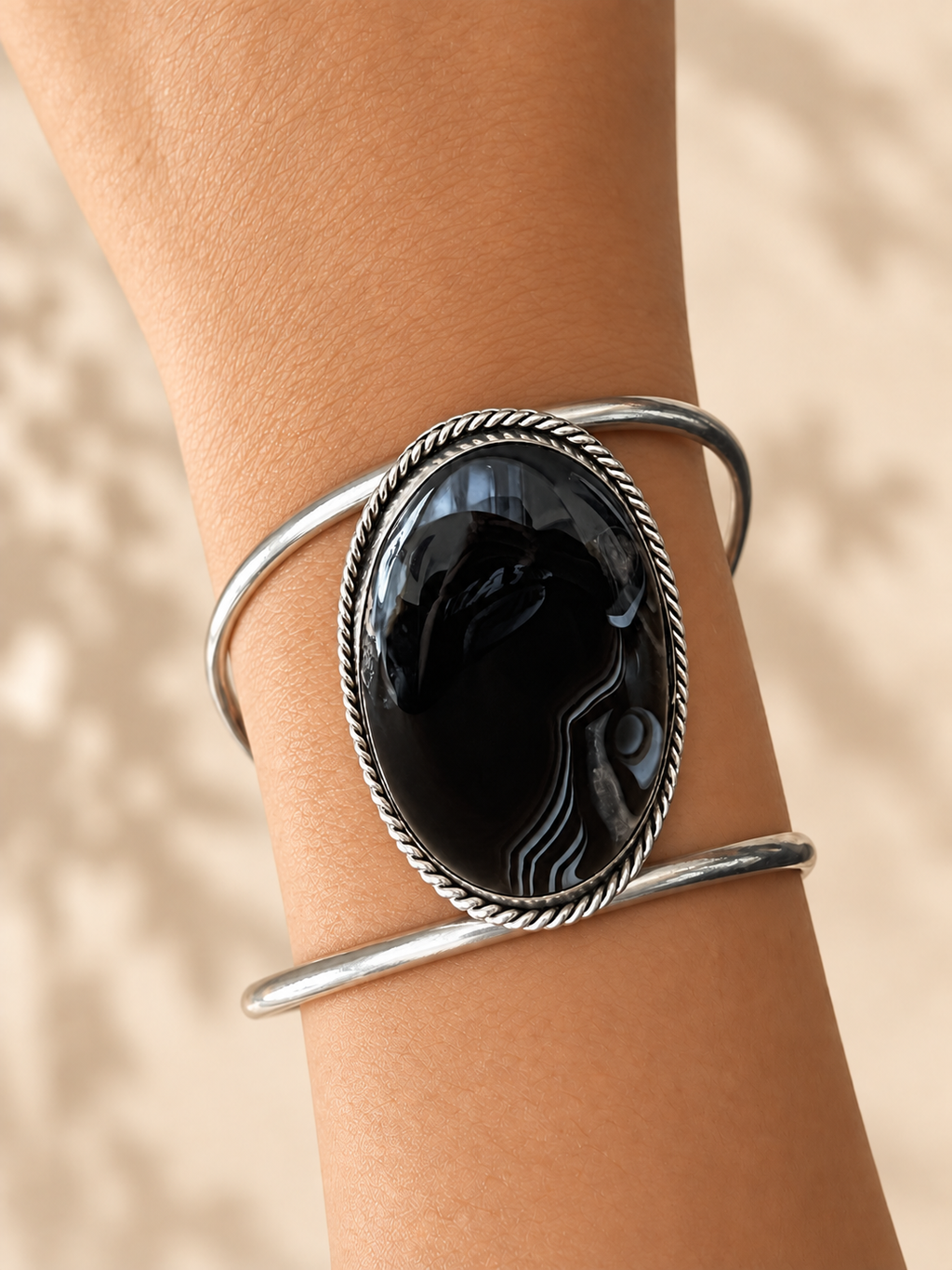 Cuff 04 — Black Oval Twisted Edge — hand try-on